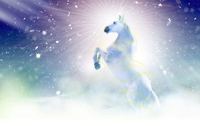 A beautiful white horses is raised on its hind legs with bright shiny rays of light coming down around it.